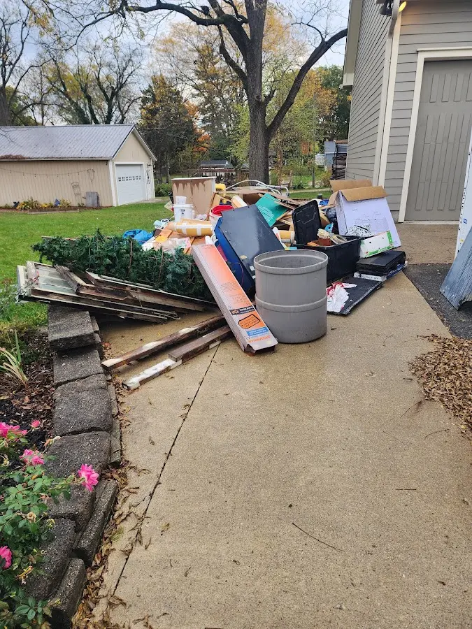 Dumpster being loaded with debris for Estate Cleanout Dumpster Rental in Anderson